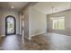 Inviting entryway with tile floors, an arched doorway, neutral walls, and a wrought iron door, offering a glimpse into the home at 36172 N Secret Garden Path, Queen Creek, AZ 85140