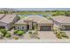 Stunning single-story home with lush landscaping, neutral tones, three-car garage, and a beautiful view of the golf course and lake at 36172 N Secret Garden Path, Queen Creek, AZ 85140