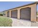 Three car garage with tan siding with pavers leading to the garage at 36172 N Secret Garden Path, Queen Creek, AZ 85140
