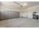 Spacious garage featuring built-in storage cabinets, utility sink, and water filtration system at 36172 N Secret Garden Path, Queen Creek, AZ 85140