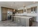 Modern kitchen with stainless steel appliances, a center island, and stylish backsplash at 36172 N Secret Garden Path, Queen Creek, AZ 85140
