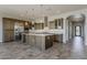 Spacious kitchen features a large island, stainless steel appliances, and stylish pendant lighting at 36172 N Secret Garden Path, Queen Creek, AZ 85140