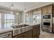 Gourmet kitchen with stainless steel appliances, large island, and view of the backyard at 36172 N Secret Garden Path, Queen Creek, AZ 85140