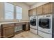 Laundry room with washer and dryer, and custom cabinets at 36172 N Secret Garden Path, Queen Creek, AZ 85140