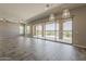 Bright living area with tile flooring, large sliding glass doors to the outdoor patio, and overhead lighting at 36172 N Secret Garden Path, Queen Creek, AZ 85140