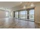 Bright living room with tile flooring and access to covered patio through large sliding glass doors at 36172 N Secret Garden Path, Queen Creek, AZ 85140