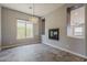 Living room with large window, modern lighting, and tile floors at 36172 N Secret Garden Path, Queen Creek, AZ 85140