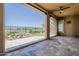 Covered patio showcasing stone floors with a rock water feature and a view of the golf course at 36172 N Secret Garden Path, Queen Creek, AZ 85140