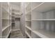 Large walk-in closet with custom shelving at 36172 N Secret Garden Path, Queen Creek, AZ 85140