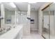Well-lit bathroom with double sink vanity, large mirror, and glass enclosed shower and tub area at 3755 E Broadway Rd # 36, Mesa, AZ 85206