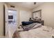 Bedroom featuring tiled floors, neutral walls, a comfortable bed, and an open doorway to another room at 3755 E Broadway Rd # 36, Mesa, AZ 85206