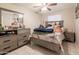 This is a bedroom featuring tiled flooring, neutral walls and a dresser with mirror at 3755 E Broadway Rd # 36, Mesa, AZ 85206
