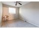 This bedroom features carpet floors, a small table, one window, and neutral colored walls at 3755 E Broadway Rd # 36, Mesa, AZ 85206