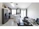 Charming dining area with modern black table set, adjacent to a kitchen with stainless steel appliances at 3755 E Broadway Rd # 36, Mesa, AZ 85206