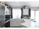 Bright and modern kitchen with white cabinetry, stainless appliances, and sleek countertop finishes at 3755 E Broadway Rd # 36, Mesa, AZ 85206