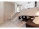 Inviting living room showcasing a modern staircase, plush seating, and stylish tile flooring at 3755 E Broadway Rd # 36, Mesa, AZ 85206