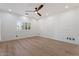 Bright bedroom featuring light wood floors, white walls, and an elegant ceiling fan at 4278 E Del Rio Dr, San Tan Valley, AZ 85140
