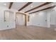 Open living room with wood beam features, white walls, and light wood flooring throughout at 4278 E Del Rio Dr, San Tan Valley, AZ 85140