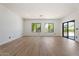Bright, open living room features light wood floors, white walls, and large glass sliding doors at 4278 E Del Rio Dr, San Tan Valley, AZ 85140
