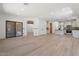 Open concept living space with kitchen, living, and dining areas, and wood-look tile flooring at 4278 E Del Rio Dr, San Tan Valley, AZ 85140
