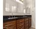 Bathroom vanity featuring double sinks, granite countertops, and wood cabinets at 4332 S Oregon Ct, Chandler, AZ 85248