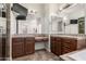 Bathroom vanity area featuring sconce lighting, tile counters, and dark wood cabinetry at 4332 S Oregon Ct, Chandler, AZ 85248