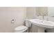 Powder bathroom featuring white toilet, vessel sink with chrome faucet, and neutral paint at 4332 S Oregon Ct, Chandler, AZ 85248