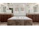 Spa-like bathroom with large tub, double sinks, and decorative mirrors and lighting at 4332 S Oregon Ct, Chandler, AZ 85248