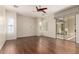 Bright bedroom with hardwood floors, shuttered windows, and a sliding glass door leading to the patio at 4332 S Oregon Ct, Chandler, AZ 85248