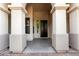 Inviting front entrance with stately columns, a dark wood door, and a view of the interior at 4332 S Oregon Ct, Chandler, AZ 85248