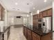 Beautiful kitchen with a large island, stainless steel appliances, and view into an additional living space at 4332 S Oregon Ct, Chandler, AZ 85248