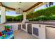 This outdoor kitchen features stainless steel appliances and plenty of counter space for entertaining at 4332 S Oregon Ct, Chandler, AZ 85248
