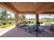 Community outdoor kitchen with covered seating and BBQ grills overlooking the beautiful pond at 4332 S Oregon Ct, Chandler, AZ 85248