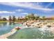 Scenic pond featuring a stone waterfall and charming gazebo, surrounded by lush landscaping at 4332 S Oregon Ct, Chandler, AZ 85248