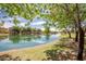 Picturesque view of the pond surrounded by mature trees and manicured lawns at 4332 S Oregon Ct, Chandler, AZ 85248