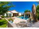Outdoor oasis with a sparkling pool, lounge chairs, fire pit, and covered patio perfect for entertaining at 4332 S Oregon Ct, Chandler, AZ 85248