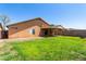 Spacious backyard with green lawn, rear house view, and covered patio perfect for entertaining at 4837 E Whitehall Dr, San Tan Valley, AZ 85140