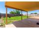 Inviting backyard featuring a covered patio, lush lawn, privacy fence, and charming fire pit at 4837 E Whitehall Dr, San Tan Valley, AZ 85140