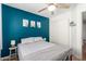 Bedroom features a blue accent wall, ceiling fan, closet, and side tables with lamps at 4837 E Whitehall Dr, San Tan Valley, AZ 85140