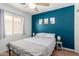 Bedroom features a blue accent wall, ceiling fan, and side tables with lamps at 4837 E Whitehall Dr, San Tan Valley, AZ 85140
