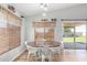 Cozy dining area with a wooden table, white chairs, and natural window coverings at 4837 E Whitehall Dr, San Tan Valley, AZ 85140
