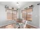 Cozy dining area with a wooden table, white chairs, and natural window coverings at 4837 E Whitehall Dr, San Tan Valley, AZ 85140