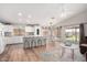 Bright, open concept kitchen features white cabinetry, an island with barstool seating and stainless steel appliances at 4837 E Whitehall Dr, San Tan Valley, AZ 85140