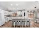 Bright, open concept kitchen features white cabinetry, an island with barstool seating and stainless steel appliances at 4837 E Whitehall Dr, San Tan Valley, AZ 85140