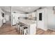 Bright kitchen with white cabinets, an island with seating, and modern appliances at 4837 E Whitehall Dr, San Tan Valley, AZ 85140