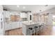 Bright kitchen featuring white cabinetry, a central island with barstool seating, and modern appliances at 4837 E Whitehall Dr, San Tan Valley, AZ 85140