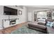 Contemporary living area featuring a large TV, hardwood floors, and stylish decor for entertainment and relaxation at 4837 E Whitehall Dr, San Tan Valley, AZ 85140