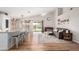 Open-concept living area with hardwood floors, modern furnishings, and abundant natural light streaming through sliding doors at 4837 E Whitehall Dr, San Tan Valley, AZ 85140