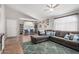 Inviting living room with a comfortable sectional sofa, hardwood floors, and natural light, perfect for relaxation at 4837 E Whitehall Dr, San Tan Valley, AZ 85140