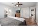 Spacious main bedroom features ceiling fan, wood floors, closet, and ensuite bathroom at 4837 E Whitehall Dr, San Tan Valley, AZ 85140